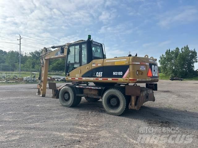 CAT M318D حفارات بعجل
