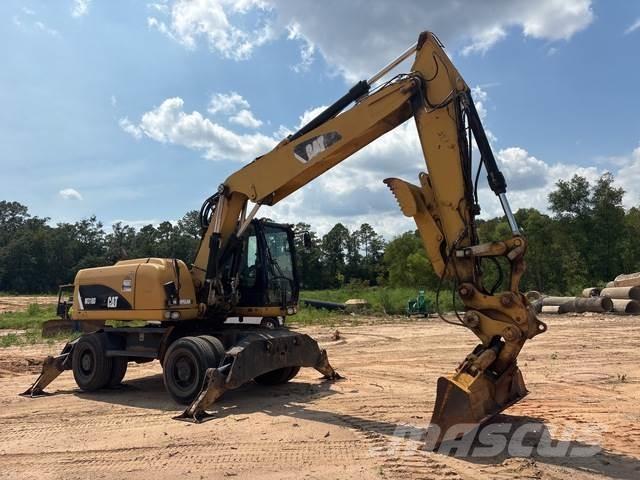 CAT M318D حفارات بعجل