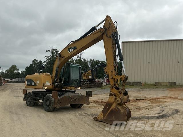 CAT M318D حفارات بعجل