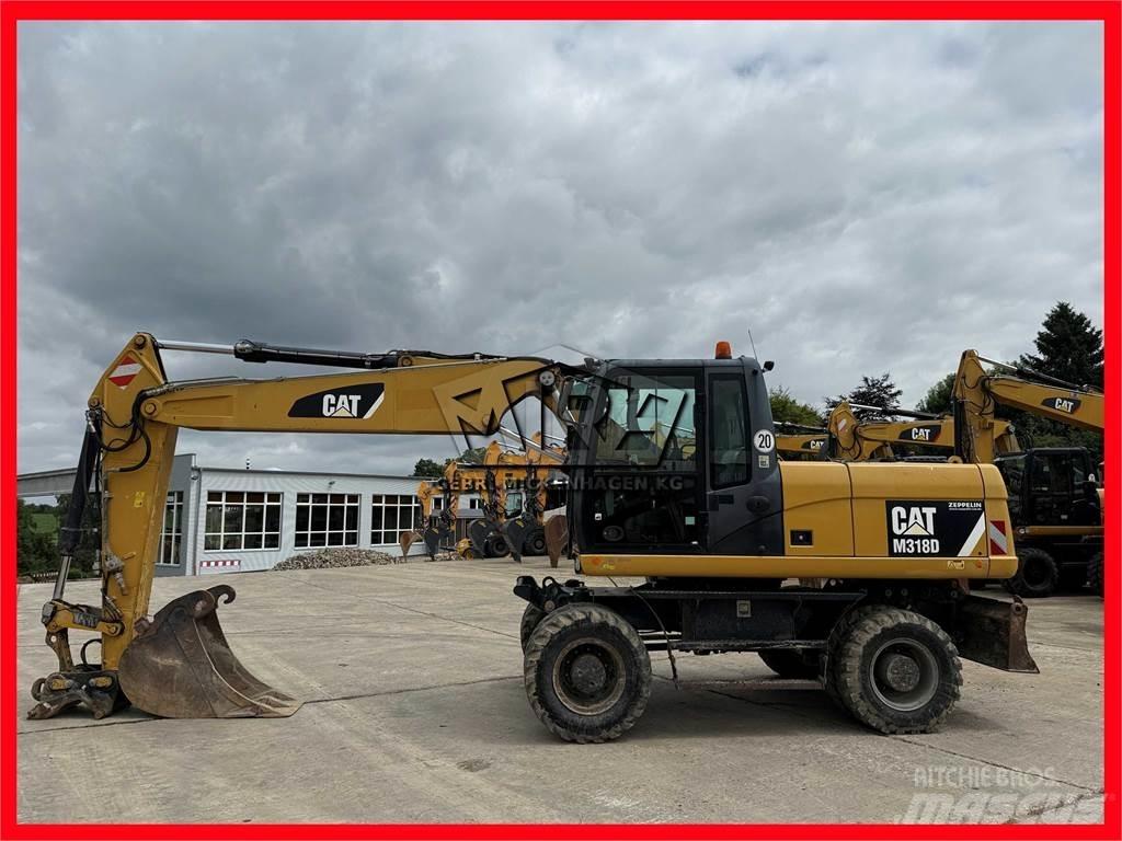 CAT M 318 D حفارات بعجل