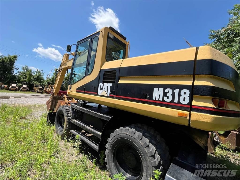 CAT M318 حفارات بعجل
