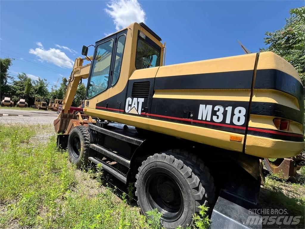 CAT M318 حفارات بعجل