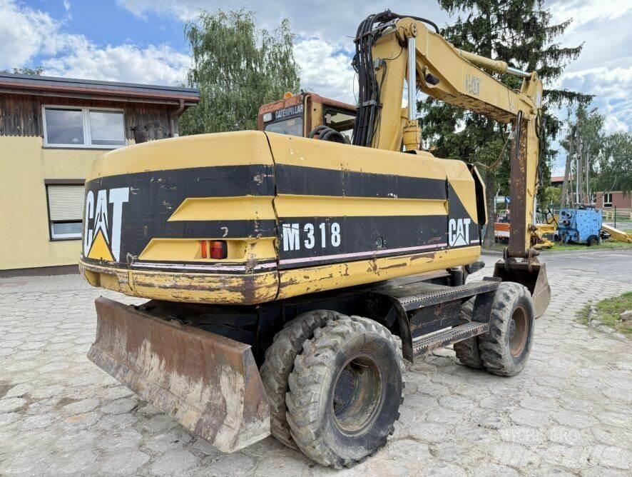CAT M318 حفارات بعجل