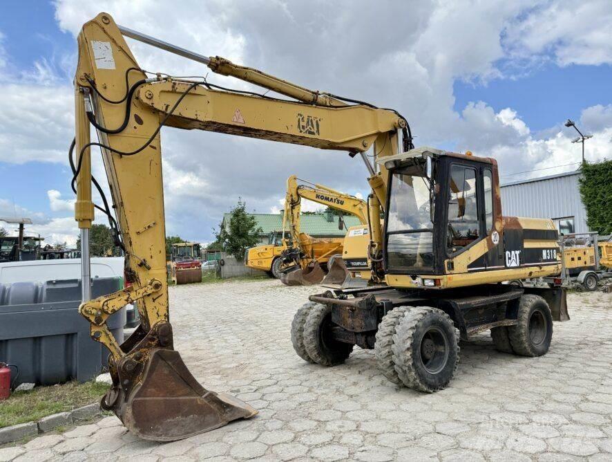 CAT M318 حفارات بعجل